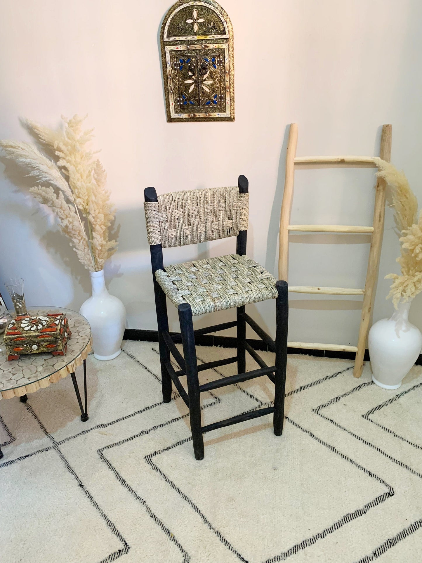 a room with a chair, vases and a ladder