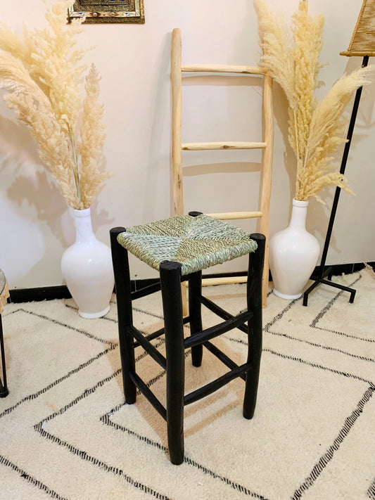 a chair and two vases in a room