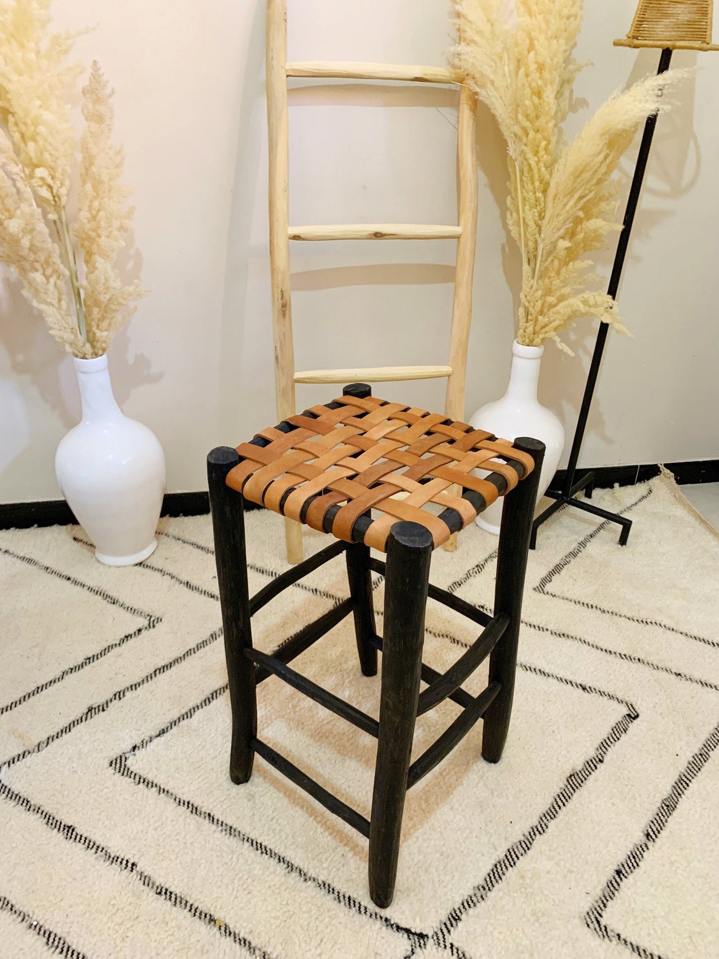 a chair and a vase sitting on a rug