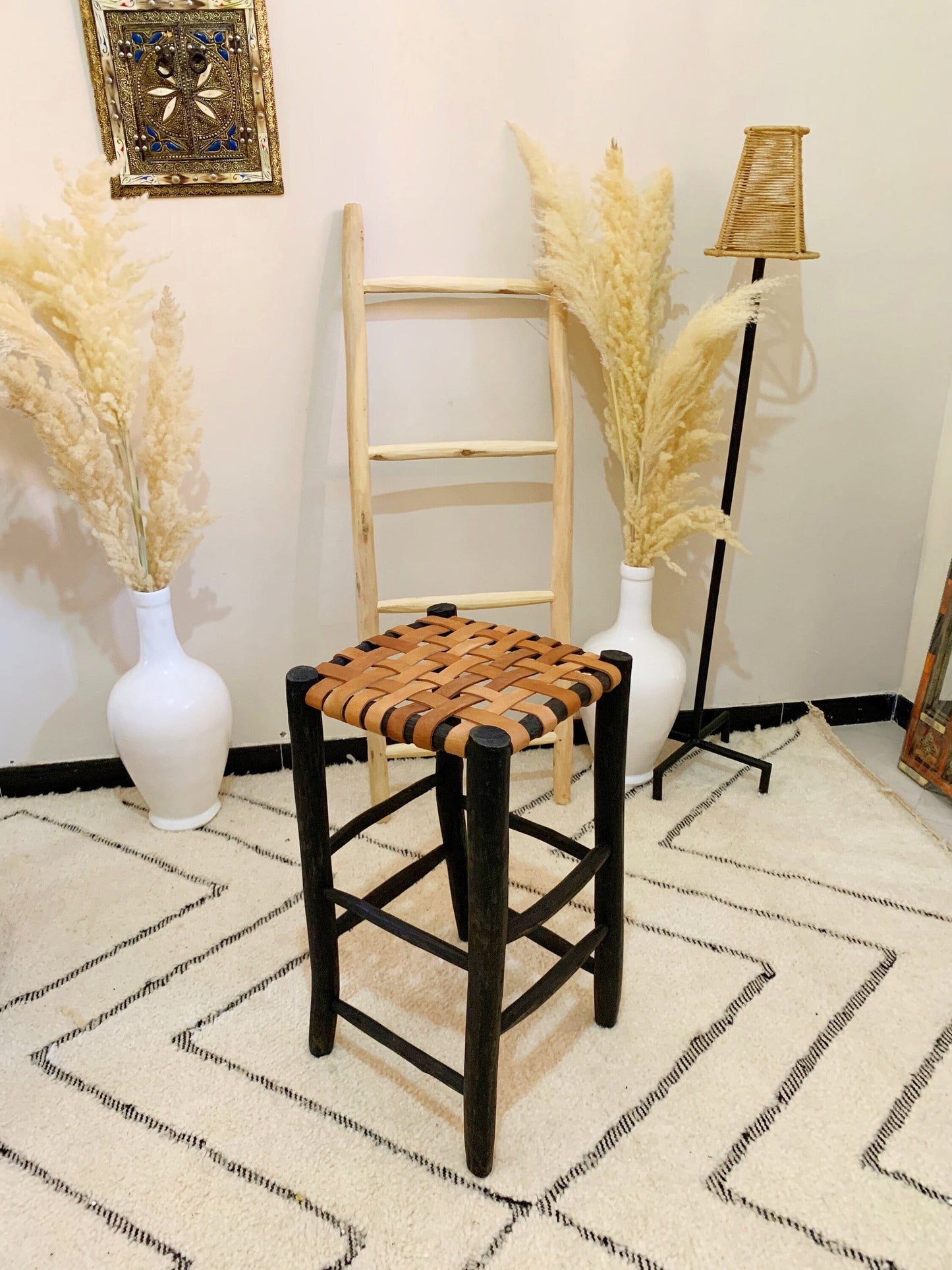 a chair with a woven seat sits in a room