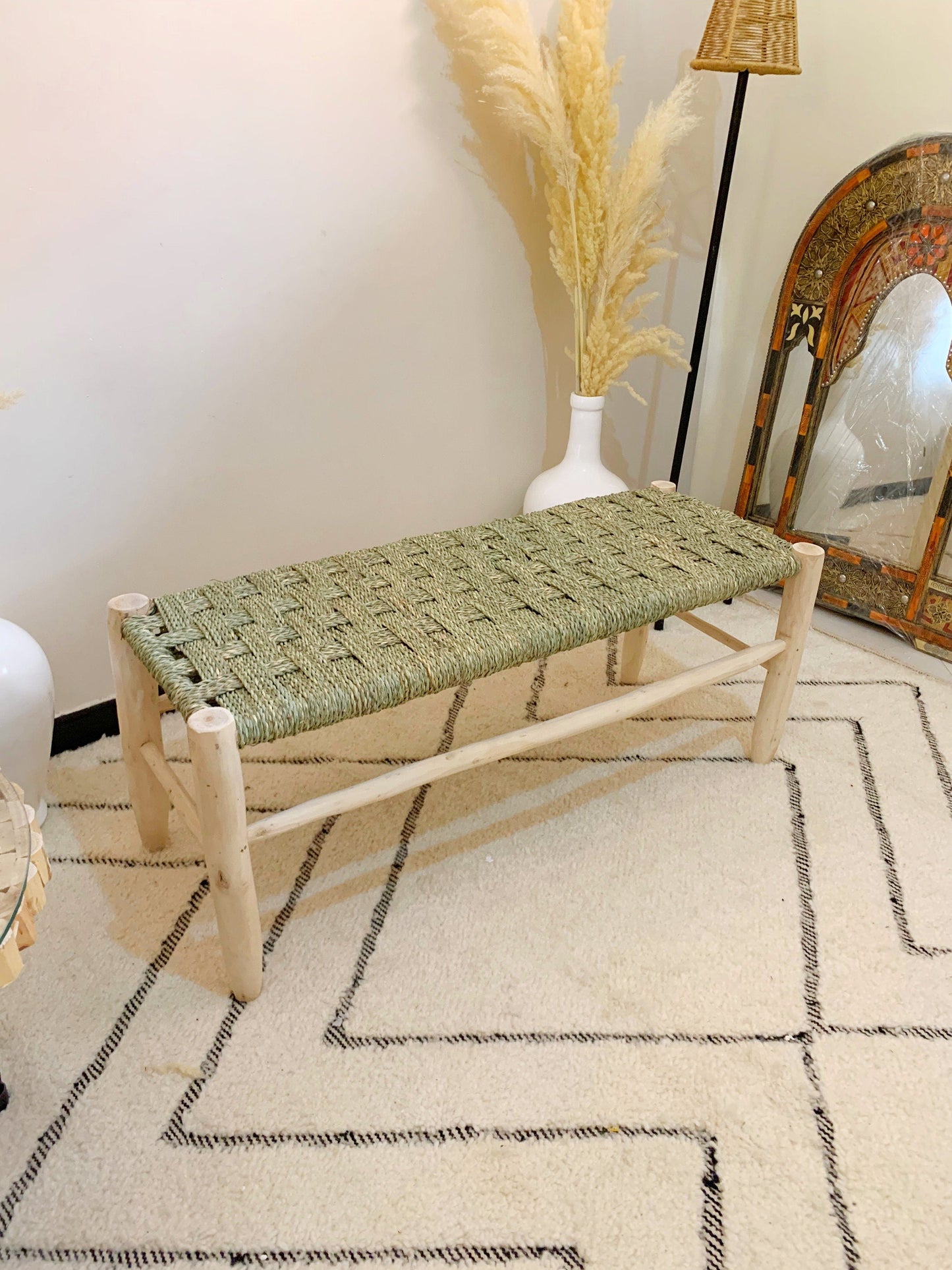 a wooden bench sitting on top of a white rug