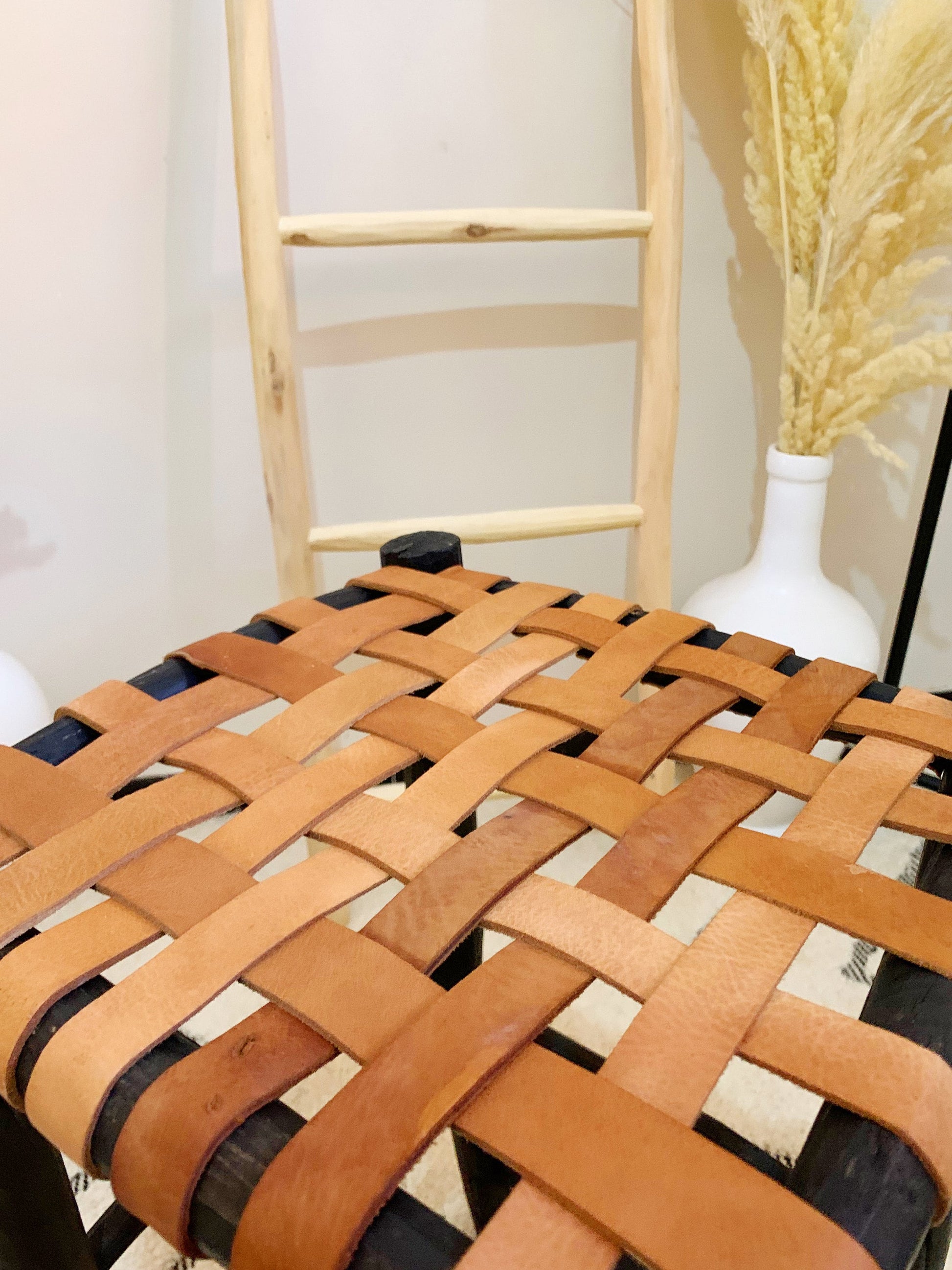 a wooden chair with a woven seat cushion