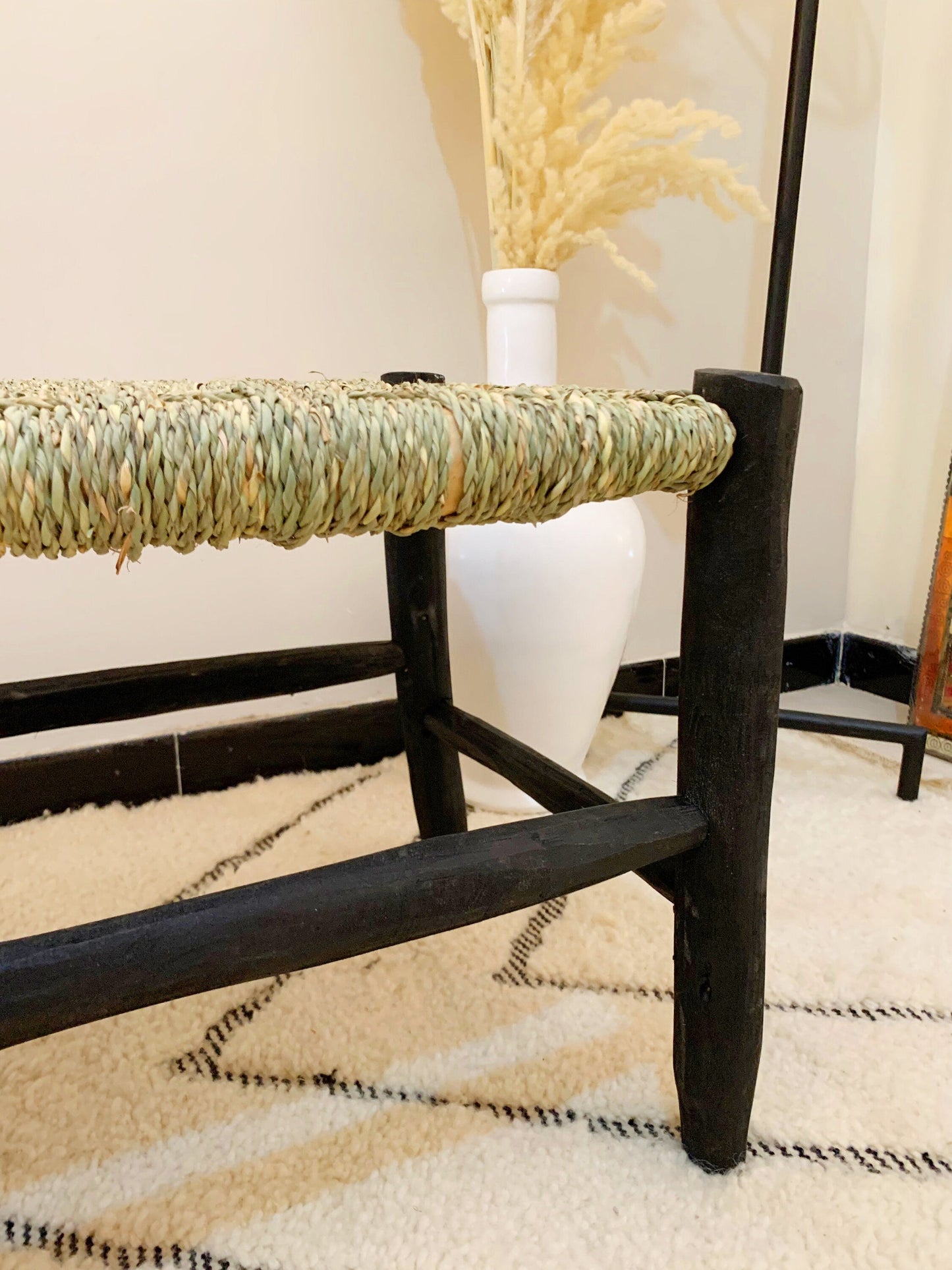 a wooden bench sitting on top of a white rug