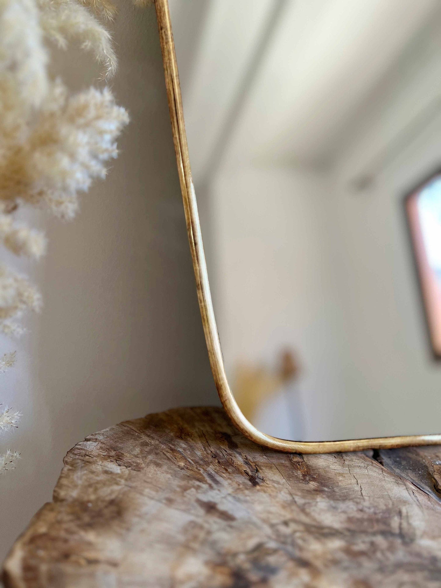 a mirror sitting on top of a wooden table